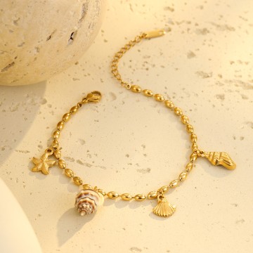 Bracelet Naïa doré avec charms étoile de mer et coquillages